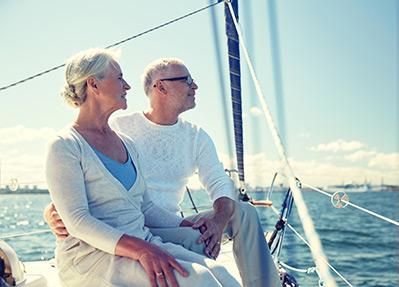 mature couple sitting on a sailboat