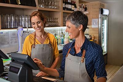 two female business owners working in a shop